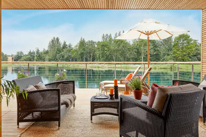 picture of a table and chairs overlooking water