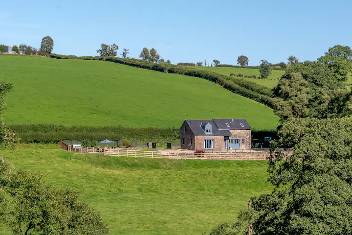 picture of a cottage overlooking fields